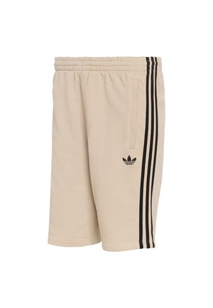 Beige Baumwollshorts mit elastischem Bund und Seitentaschen. Schwarzes Design mit drei Streifen entlang der Seiten. Kleines schwarzes Logo am Oberschenkel.