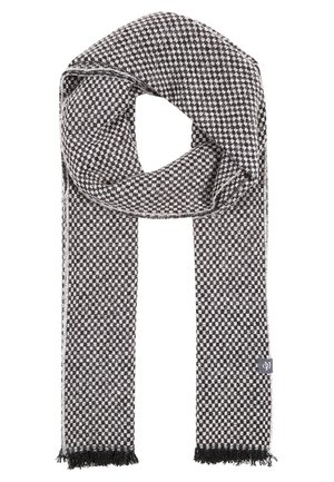 Schwarz-weiß kariertes Wollschal mit Fransenenden und einem kleinen rechteckigen Markenschild auf einer Seite.