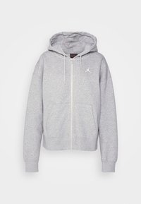 Sudadera gris con cremallera hecha de tela de sudadera, con un bolsillo canguro delantero, capucha ajustable y un logo de Jordan blanco en el pecho.