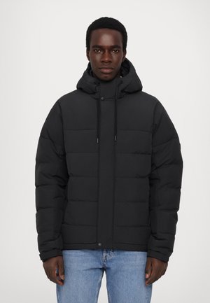 Black puffer jacket featuring a hood, front snap closure, and drawstrings. Textured quilted design with a relaxed fit.