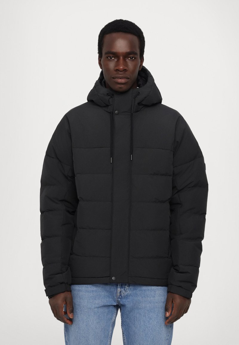 Black puffer jacket featuring a hood, front snap closure, and drawstrings. Textured quilted design with a relaxed fit.
