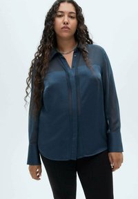Navy sheer long-sleeve shirt with front button closure, collar, and two horizontal stripes. Textured fabric with a glossy finish.