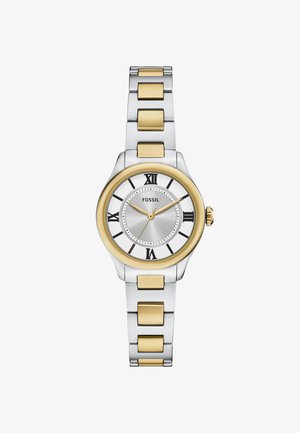 Sølv- og guldfarvet Fossil ur med rund urskive, romertal markeringer og et armbånd i rustfrit stål med børstede og polerede overflader.