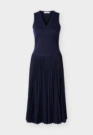 Brezrokavna obleka v mornarsko modri barvi z V-izrezom in nagubano midi krilo, z majhno vezeno logotipom na prsih.