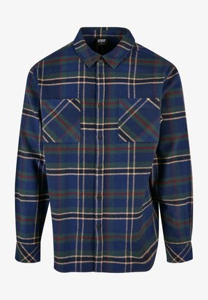 Pitkähihainen flanellipaita tummansinisessä värissä, jossa on vihreä, punainen ja kermavärinen ruutukuvio. Ominaisuuksiin kuuluu kaksi rintataskua ja napitettavuus edessä.