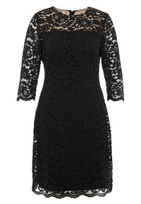 Svart spetsklänning med blommönster, trekvartslånga ärmar och scallopad fåll. Fodrad byst med rund halsringning.