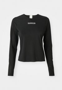 Zwarte mesh top met lange mouwen en ronde hals, met het witte "CALVIN KLEIN" logo in het midden van de borst.