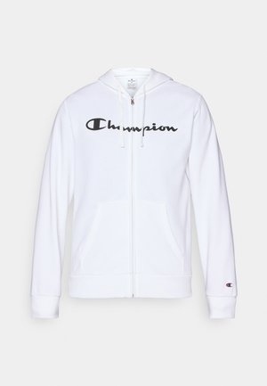 White zip-up hoodie made of soft fabric, featuring a black "Champion" logo on the chest, kangaroo pockets, and ribbed cuffs.