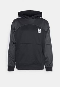 Felpa nera con cappuccio e tasca frontale. Presenta una texture liscia, cuciture curve e strisce bianche a contrasto lungo le maniche. Logo Nike presente.