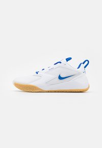 White athletic shoes with blue accents, featuring a textured rubber sole and a sleek, streamlined design. Includes a nylon tab for easy wear.