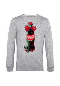 Felpa grigia con una grafica di una bottiglia di Coca-Cola decorata con un fiocco rosso, foglie di agrifoglio e bacche, stampata in colori vivaci sul davanti.