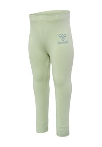 Ljusgröna leggings gjorda av mjukt material, med en stretch-resår i midjan och en liten blå logotyp på vänster höft.