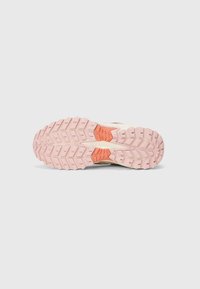 Trailrunning-Schuhsohle mit dickem rosa Gummi, tiefem Profil, orangefarbener Akzent und strukturiertem Oberflächen für besseren Halt.