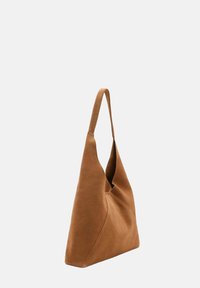 Brown suede shoulder bag with a slouchy shape, long handle, and a stitched detail on one side, featuring a smooth texture.