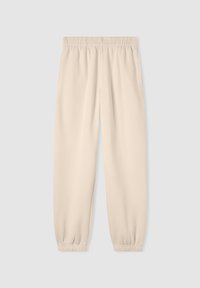 Pantaloni jogger beige realizzati in tessuto morbido, dotati di una vita elastica, caviglie elastiche e tasche laterali. Texture liscia con un design semplice.