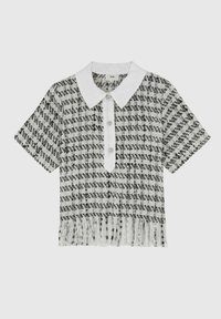 Haut à manches courtes, avec col, en motif à carreaux noir et blanc, comportant trois boutons décoratifs et un ourlet à franges. Tissu texturé au design structuré.