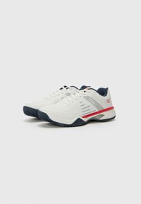 White tennis shoes with textured upper, grey and red accents, navy details, and patterned sole. Features laces and branding on the side.