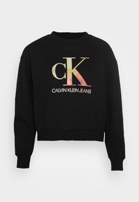 Felpa corta nera in misto cotone con logo "ck" lucido multicolore e testo "CALVIN KLEIN JEANS" sul davanti.