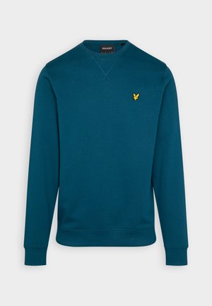 Teal genser med lange ermer, rund hals og ribbede mansjetter. Har en liten gull ørn-logo på venstre bryst. Glatt tekstur.