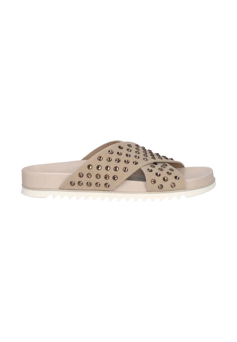 Beige slide sandals with studded upper, two crossed straps, and white zigzag sole. Made from soft material with a smooth texture.