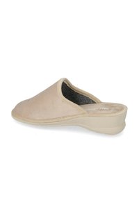 Scarpa slip-on beige con una texture morbida, punta rotonda e una suola a zeppa bassa con soletta imbottita. Accentuata da dettagli di cucitura minimi.