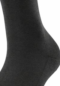 Calzino grigio scuro con una texture liscia e a coste. Presenta un tallone e una punta rinforzati, una forma affusolata e un design senza cuciture per il massimo comfort.