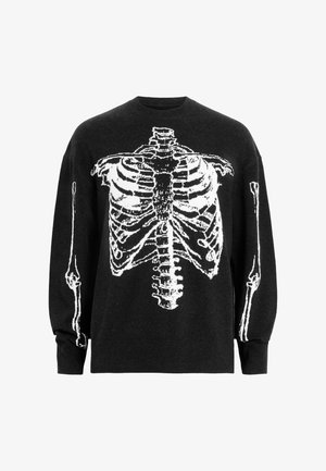 Mustmust, millel on valge skeleti graafika, mis kuvab ribide kesta ja jäsemeid. Kangas näeb välja pehme, lõdva istuvusega ning ümmarguse kaelusega.