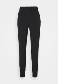 Schwarze Jogginghosen aus weichem Stoff, mit einem elastischen Bund und Kordelzug, schmal zulaufenden Beinen und gerippten Bündchen an den Knöcheln.