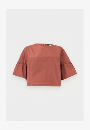 Blouse courte de couleur rouille avec des manches larges à volants arrivant aux coudes et une petite fermeture par bouton dans le dos.