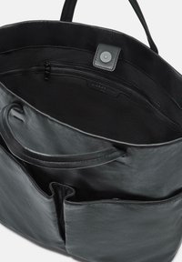 Schwarze Leder-Handtasche mit glatter Textur, ausgestattet mit einer Reißverschluss-Innentasche und einem magnetischen Druckverschluss. Zwei Tragegriffe sind sichtbar.