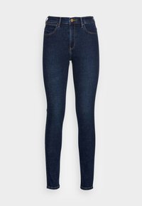 Smala jeans av mörkblå denim. Har fem fickor, knappstängning och kontrastsömmar längs sömmarna. Slät textur.