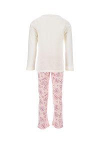 Light cream long-sleeve shirt paired with pink pants featuring a repeating floral and star pattern, made from soft cotton fabric.