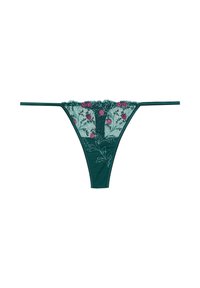 String vert en dentelle avec broderie florale rose et fines bretelles sur fond blanc.