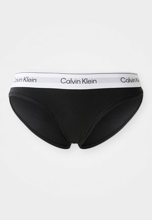 Sorte bikini-truser fra Calvin Klein for kvinner med en hvit elastisk midjebånd som har svart Calvin Klein-logo.