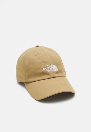 Casquette de baseball beige avec une visière courbée et le logo "The North Face" brodé en blanc au centre à l'avant.