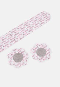 Flower-shaped hair clips with light gray centers, surrounded by white backing printed with red "MAGIC" text, on a white background.