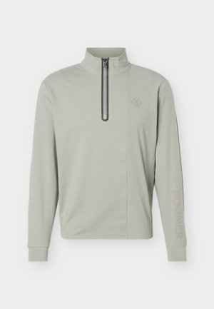 Lichtgrijze lange mouwen trui met halve rits aan de voorkant, opstaande kraag, klein rond logo op de borst en geperforeerde tekst "Bogner" op de linkermouw.