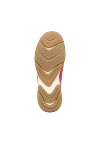 Rubber sneaker outsole featuring a herringbone tread pattern, in tan with raised circular and triangular textures. Logo visible near heel.