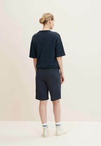 Navy cotton blend oversized t-shirt and shorts set, featuring a relaxed fit, short sleeves, and side pockets. Suitable for casual wear.