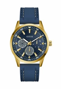Goldfarbener Uhr mit einem navyblauen Silikonarmband. Verfügt über ein dunkelblaues Zifferblatt, silberne Akzente und Unterzifferblätter zur Anzeige von Tag und Datum.