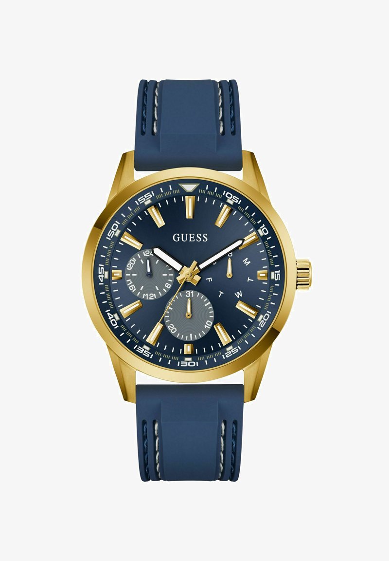 Reloj dorado con correa de silicona azul marino. Presenta una esfera azul oscura, acentos plateados y sub-esferas para la visualización del día y la fecha.