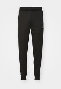 Pantalones deportivos negros con un ajuste entallado, cinturilla elástica, bolsillos laterales y rayas blancas en los lados. Presenta un pequeño logo en el muslo izquierdo.