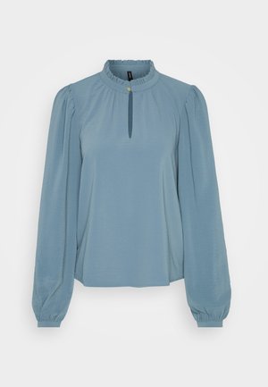 Light blue long-sleeve blouse with a ruffled collar, keyhole neckline, and gathered sleeves, made from a smooth, stretchy fabric.