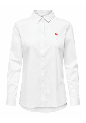Valge pika varrukaga särk, millel on terav krae, vasakul rinnal on väike punane südame tikand ja ees on nööp kinnitused.