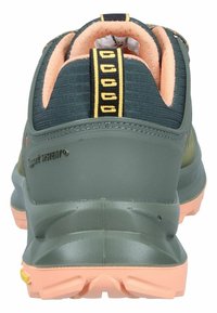 Green hiking shoe with a textured fabric and rubber sole. Features a pink accent on the sole and a padded collar with yellow detailing.