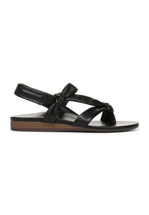 Black leather sandal with knotted design and slingback strap. Flat sole features a wood-like accent, suitable for casual wear.