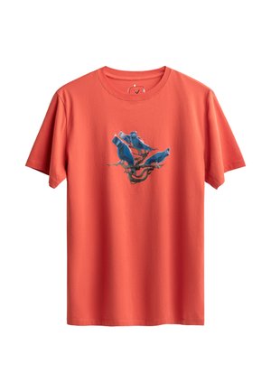 Red cotton t-shirt with short sleeves, featuring a blue bird graphic in the center on a branch, with a crew neck and relaxed fit.