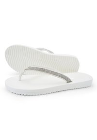 White flip-flops with a smooth rubber sole, featuring a textured pattern. The strap is embellished with silver rhinestones.