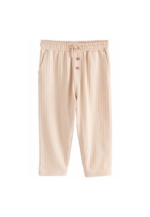 Pantalones texturizados de color beige claro con cinturilla elástica, cordón, bolsillos frontales y tres botones decorativos. Presenta un patrón de rayas.