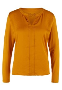 Haut à manches longues en jaune moutarde, fabriqué en tissu léger. Présente un décolleté en V avec un pli central et une texture lisse.